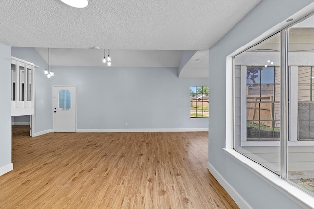 empty room featuring light hardwood / wood-style floors and a textured ceiling