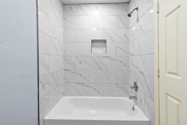 bathroom featuring tiled shower / bath