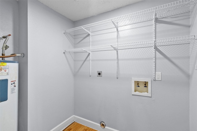 laundry area with wood-type flooring, hookup for a washing machine, electric dryer hookup, and water heater