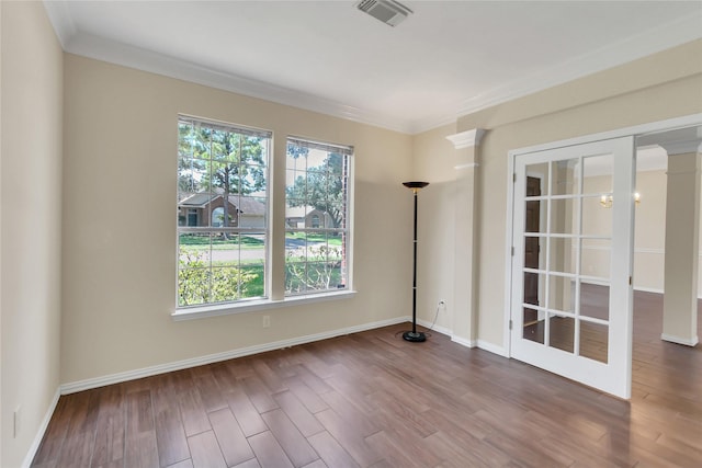 unfurnished room featuring hardwood / wood-style flooring and crown molding