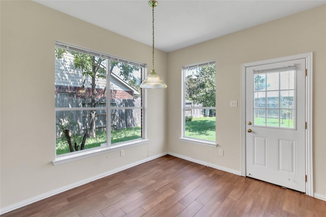 unfurnished dining area featuring hardwood / wood-style flooring