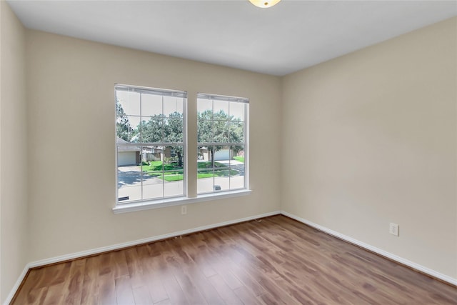 spare room with hardwood / wood-style floors