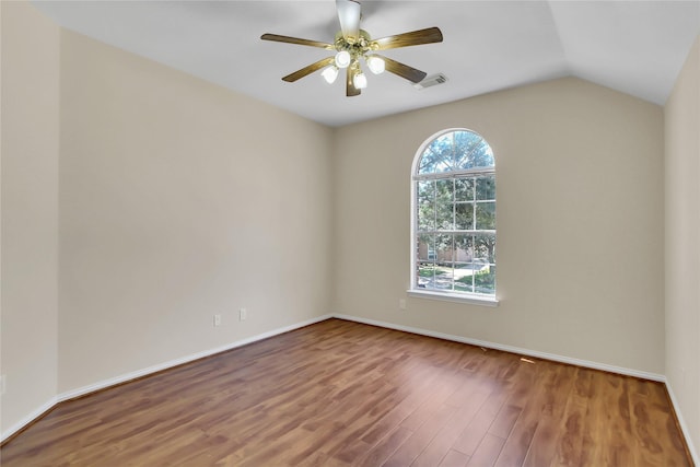 empty room with hardwood / wood-style floors, vaulted ceiling, and ceiling fan