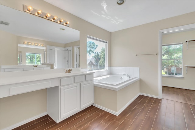 bathroom featuring vanity and shower with separate bathtub