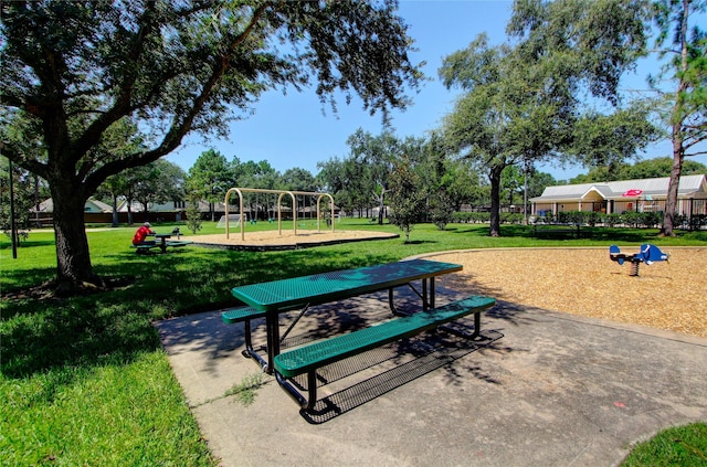 view of property's community featuring a playground and a yard