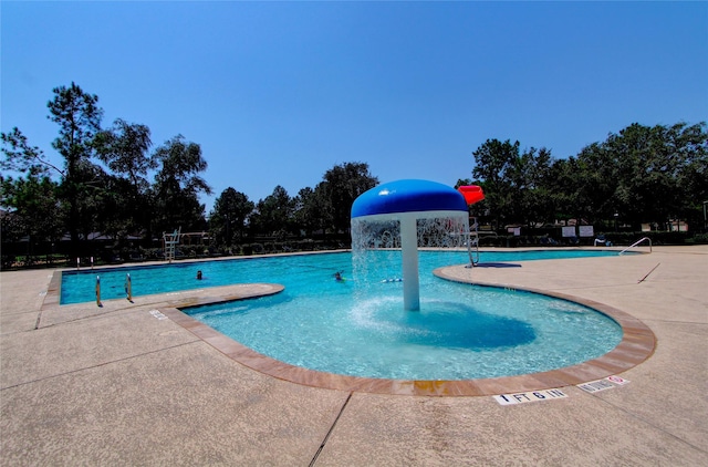 view of pool featuring pool water feature and a patio