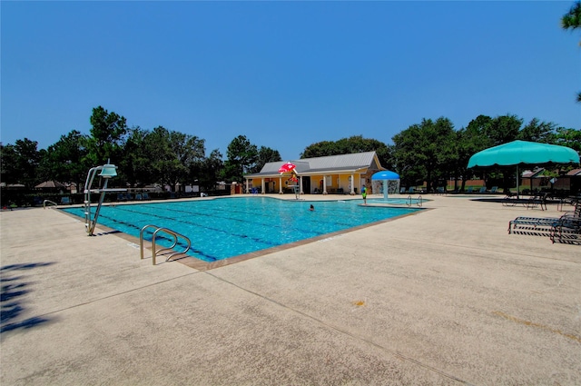 view of swimming pool featuring a patio and pool water feature