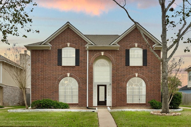 view of front of property with a yard