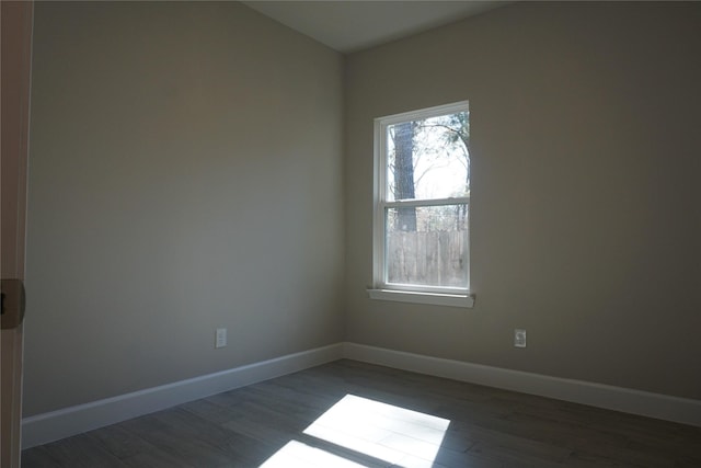 unfurnished room with dark wood-type flooring