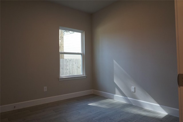 empty room with dark hardwood / wood-style flooring