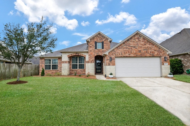 view of front of house with a front yard and a garage