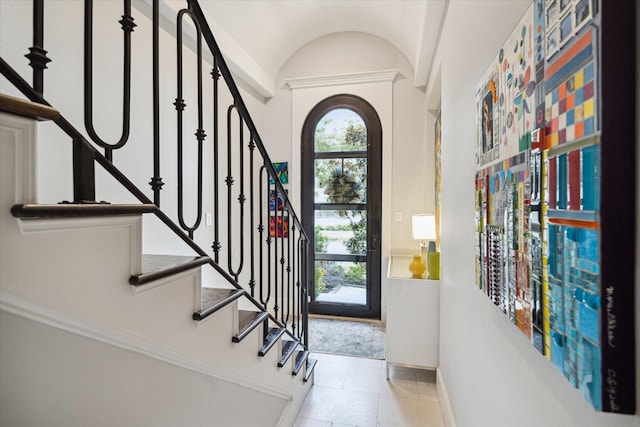 foyer entrance with vaulted ceiling and a wealth of natural light