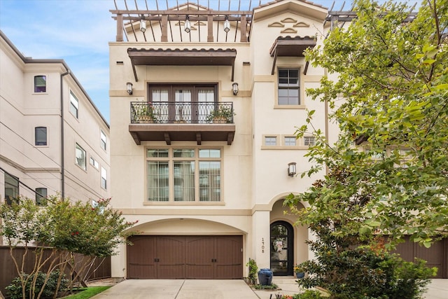 view of front of house featuring a balcony and a garage