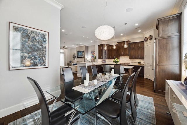 dining room featuring dark hardwood / wood-style flooring, ceiling fan, and crown molding