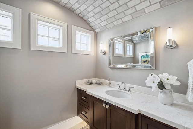 bathroom featuring vanity and brick ceiling