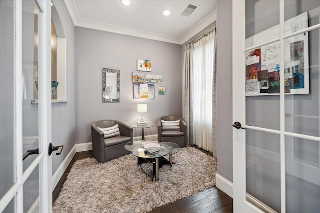 living area with dark wood-type flooring, french doors, and crown molding