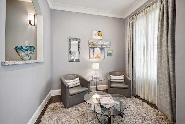 living area with crown molding and dark hardwood / wood-style floors