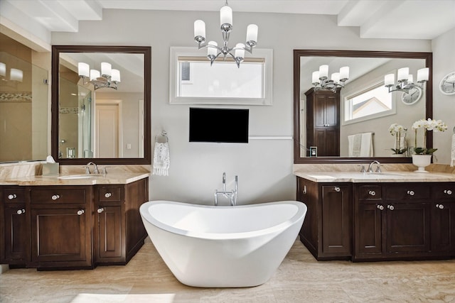 bathroom with a notable chandelier, independent shower and bath, and vanity