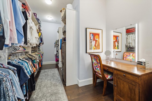 spacious closet with dark hardwood / wood-style flooring