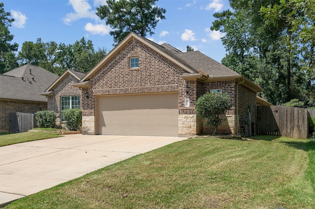 view of property featuring a garage and a front lawn