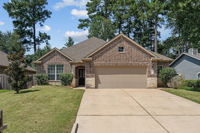 view of front of home with a front yard and a garage