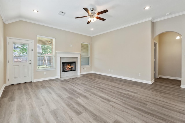 unfurnished living room featuring ceiling fan, crown molding, vaulted ceiling, and light wood-type flooring