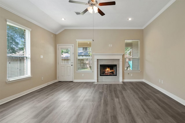 unfurnished living room featuring plenty of natural light, ceiling fan, lofted ceiling, and a tile fireplace