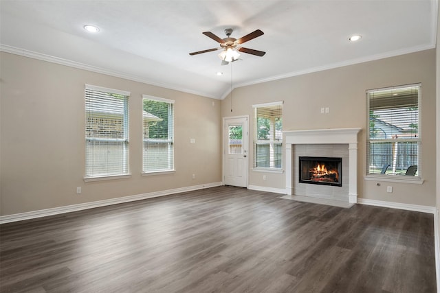 unfurnished living room with lofted ceiling, ceiling fan, dark hardwood / wood-style floors, ornamental molding, and a fireplace