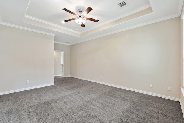 empty room with ceiling fan, crown molding, and a tray ceiling