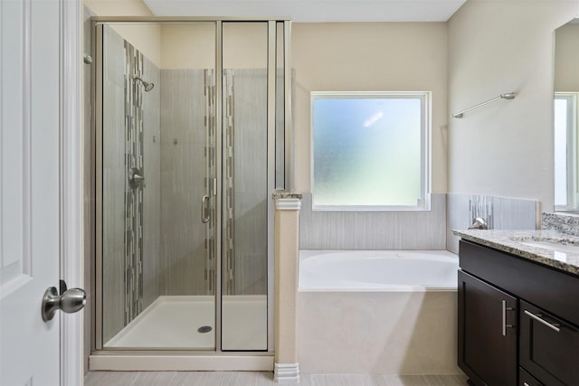 bathroom with vanity and plus walk in shower