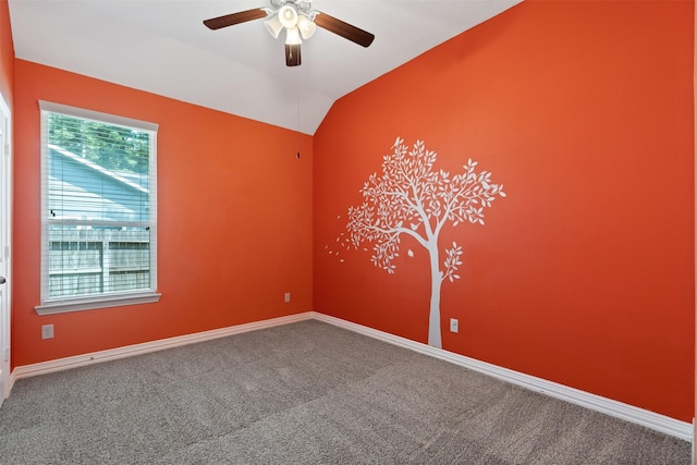 empty room featuring carpet, ceiling fan, and lofted ceiling