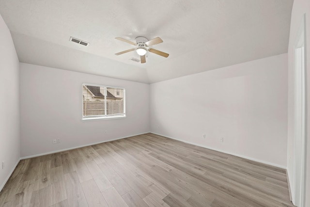 unfurnished room with ceiling fan, light wood-type flooring, and vaulted ceiling