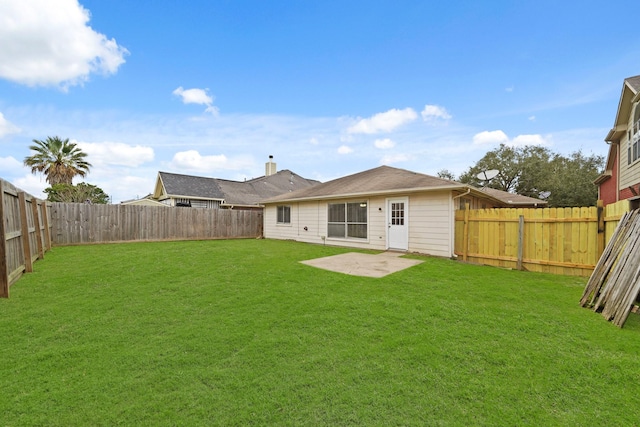 back of property featuring a patio area and a yard