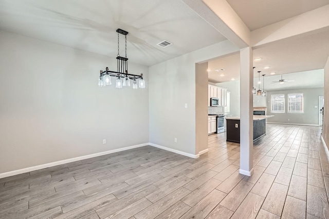 unfurnished dining area featuring ceiling fan