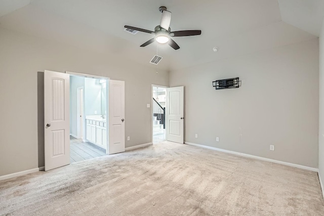 unfurnished bedroom featuring connected bathroom, light colored carpet, and ceiling fan