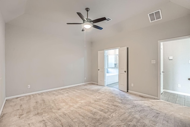 carpeted spare room with ceiling fan and lofted ceiling