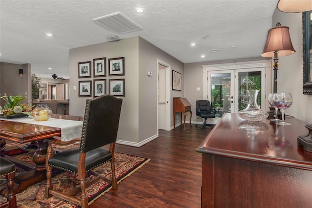 dining space featuring dark hardwood / wood-style flooring, ceiling fan, french doors, and a textured ceiling