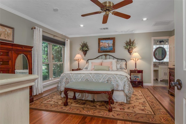 bedroom featuring connected bathroom, ceiling fan, crown molding, and hardwood / wood-style flooring