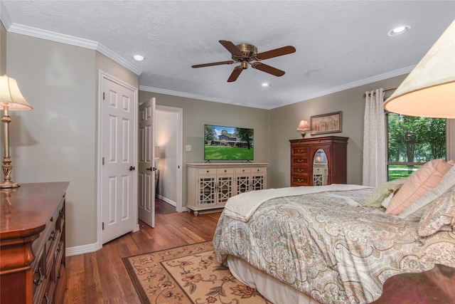 bedroom featuring ceiling fan, dark hardwood / wood-style floors, ornamental molding, and a textured ceiling