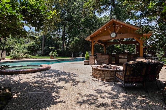 view of patio with a gazebo and a pool with hot tub