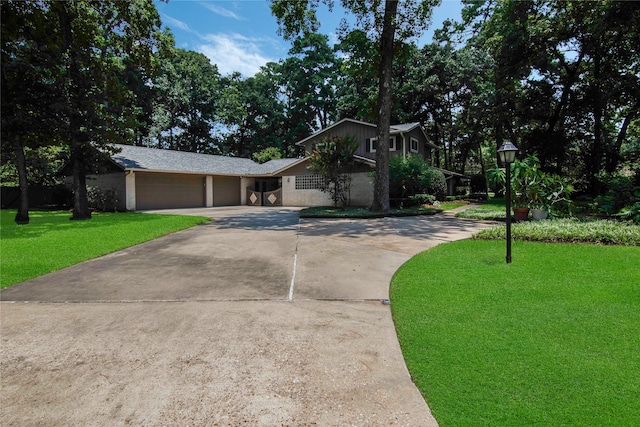 single story home featuring a garage and a front yard