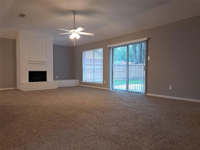 unfurnished living room with a fireplace, carpet flooring, and ceiling fan