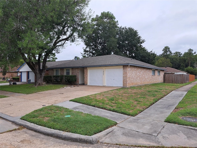 ranch-style house featuring a front lawn and a garage