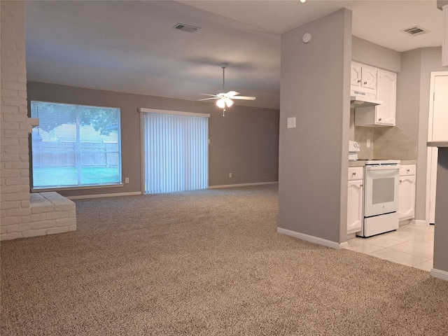 kitchen featuring white cabinetry, electric range, ceiling fan, and light colored carpet