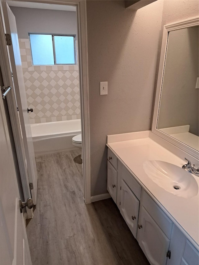 bathroom with vanity, hardwood / wood-style flooring, and toilet