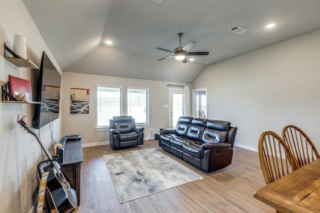 living room featuring hardwood / wood-style flooring, ceiling fan, and vaulted ceiling