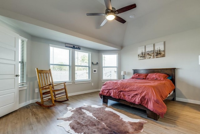 bedroom with light hardwood / wood-style floors, ceiling fan, and lofted ceiling