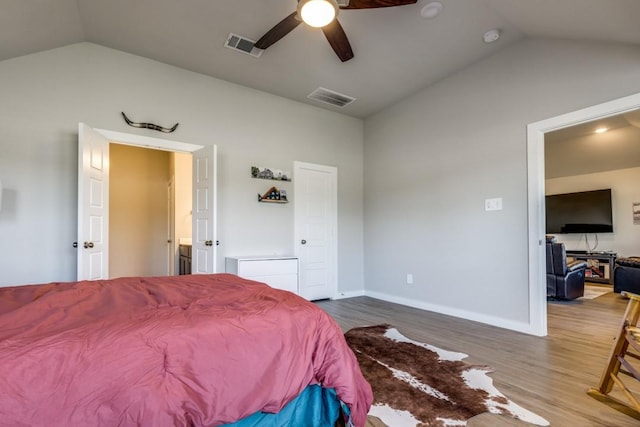 bedroom with ceiling fan, wood-type flooring, and lofted ceiling