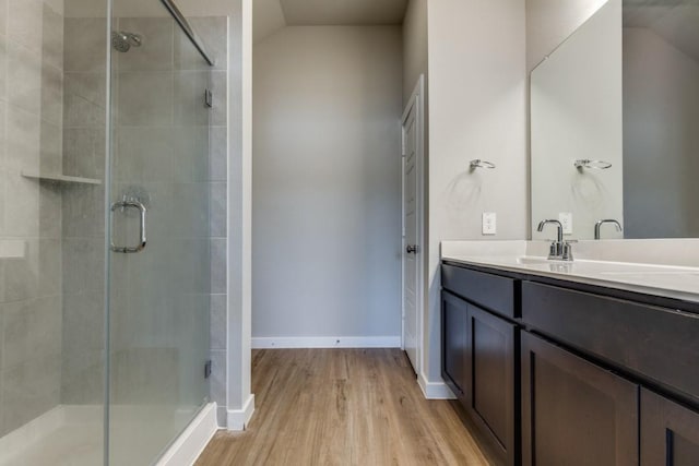 bathroom with vanity, hardwood / wood-style flooring, and walk in shower