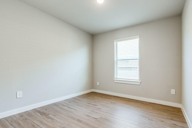 unfurnished room with light hardwood / wood-style floors